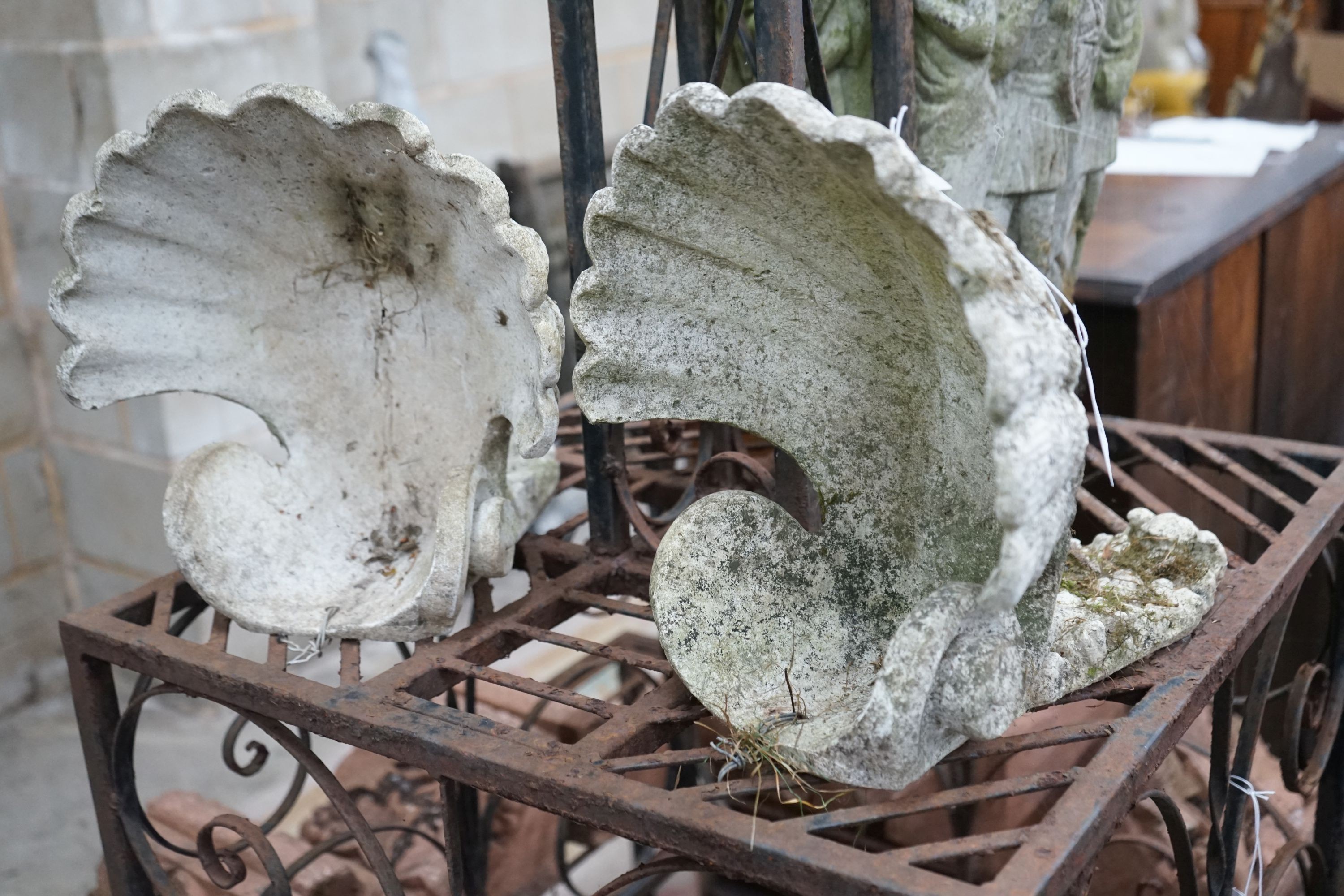 A pair of reconstituted stone scallop shell garden wall pockets, width 29cm, depth 30cm, height approx. 32cm